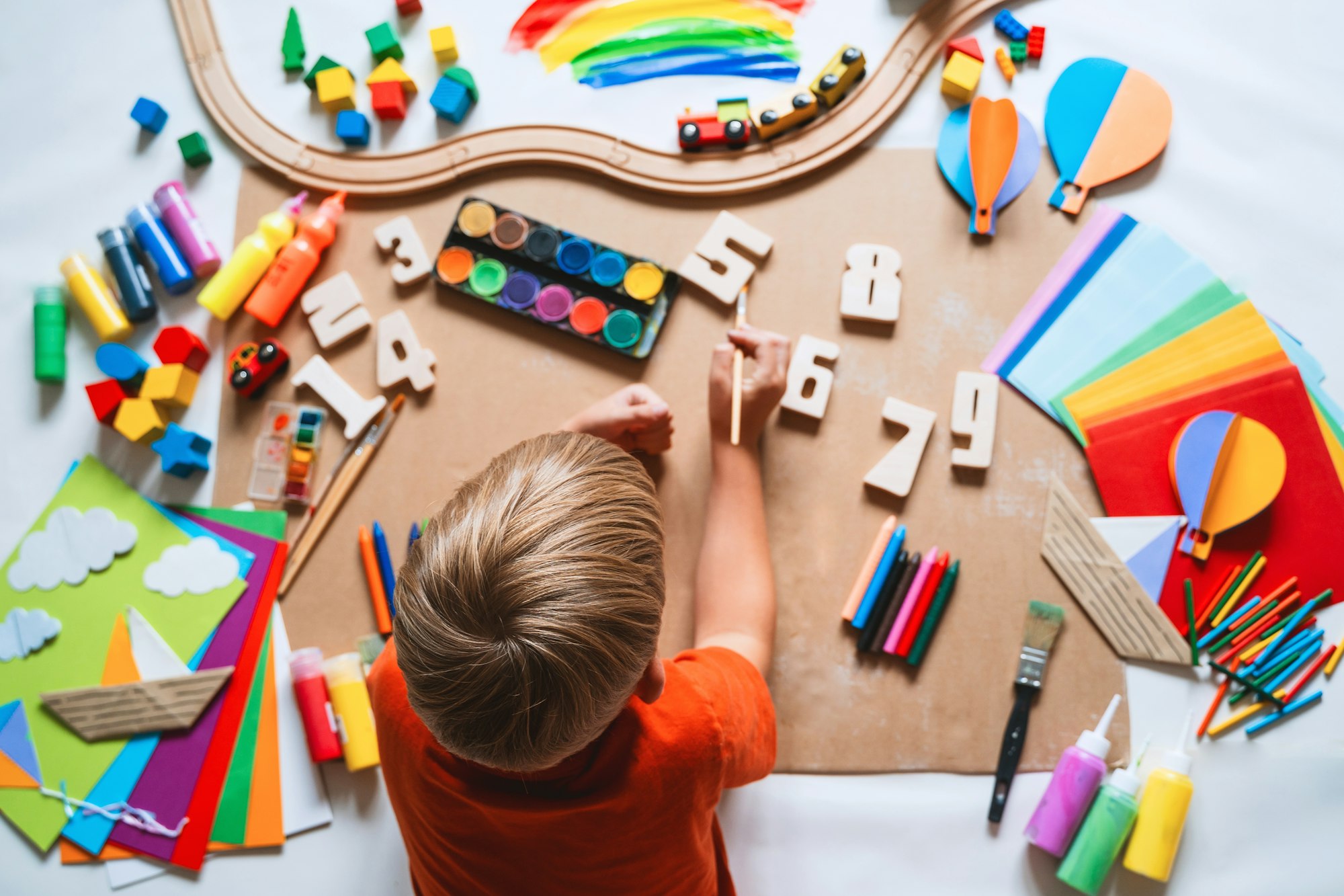 Child drawing and making crafts in school or daycare.